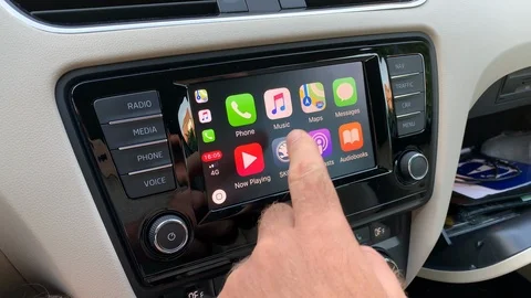 Man pressing Apple Maps button on the Apple CarPlay Stock Footage 96756000