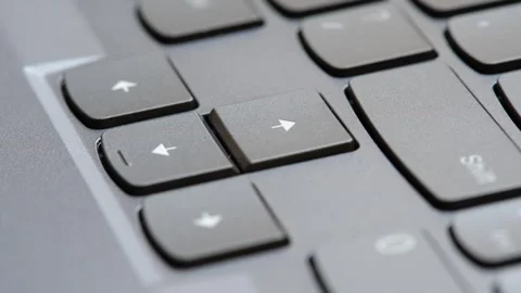 Man pressing the up arrow key on a modern laptop computer keyboard, closeup.. Stock Footage 307614250