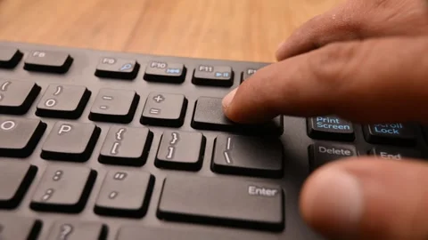 Man Pressing Backspace Key on Keyboard to Delete Text on Computer Video stock 333568980