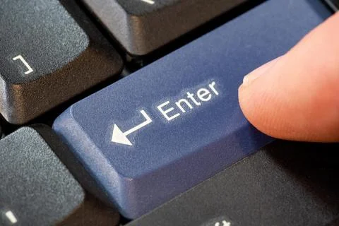 Man pressing a blue enter key on a laptop computer keyboard, hand finger ob.. Stock Photos