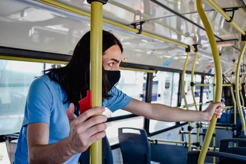 Man pressing the bus stop button Stock Photos