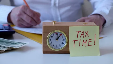 Man pressing the button of a chess clock, tax time concept Stock Footage 267539591