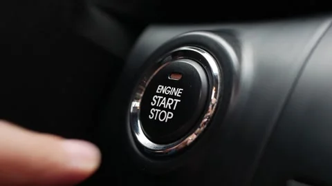 Man is pressing the button engine start in car. Start car engine by pushing a Stock Footage 143856277