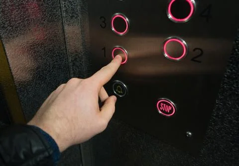 Man pressing button inside elevator. Foto stock