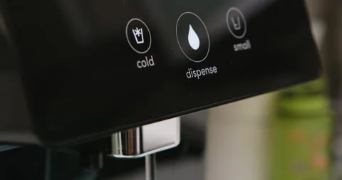 Man pressing button on water filtered machine for cold water dispensing Stock Footage 275489719