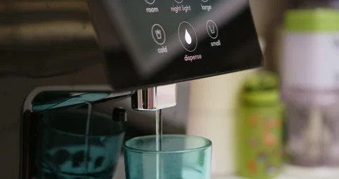 Man pressing button on water filtered machine for cold water dispensing Stock Footage 275506553