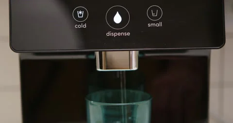 Man pressing button on water filtered machine for cold water dispensing Stock Footage 275508160