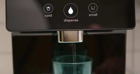Man pressing button on water filtered machine for cold water dispensing Stock Footage 275509650