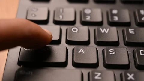 Man Pressing Caps Lock Key on Keyboard to Toggle Uppercase Typing Mode Stock Footage 333579071