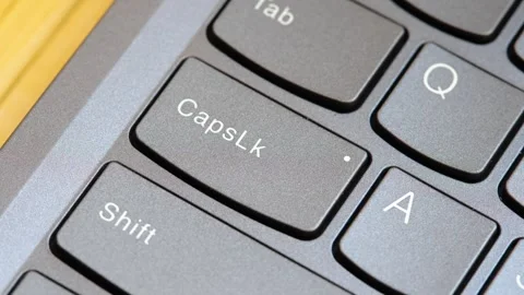 Man pressing the Capslock key on a modern laptop computer keyboard, capital.. Stock Footage 307614137