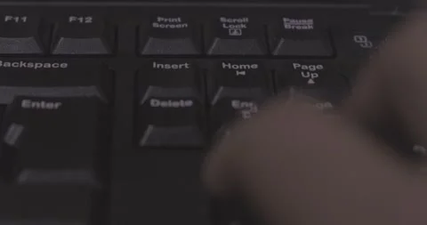 Man pressing delete key on computer keyboard, finger, macro, detail, close-up Stock Footage 232318426