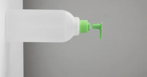 Man pressing on dispensing bottle to clean hands with sanitizer, vertical video. Stock Footage 127705859