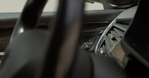 A man pressing the door unlock button in a car Stock Footage 144535967
