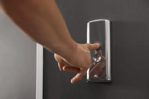 Man pressing elevator call button, closeup view Foto stock