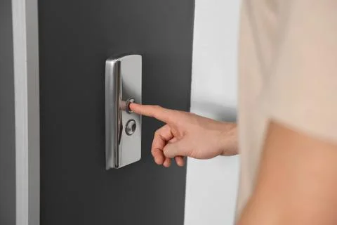 Man pressing elevator call button, closeup view Foto stock