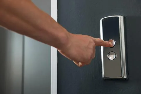 Man pressing elevator call button, closeup view Stock Photos