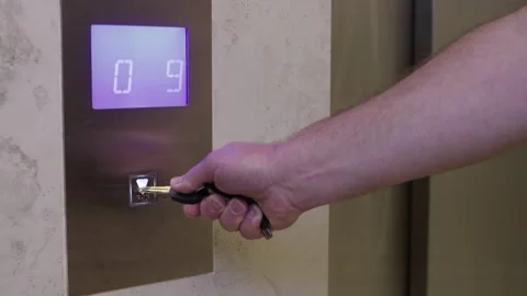 Man is pressing elevator's button with car key Stock Footage 140533022