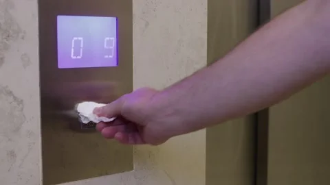 Man is pressing elevator's button with tissue or paper Stock Footage 140533030