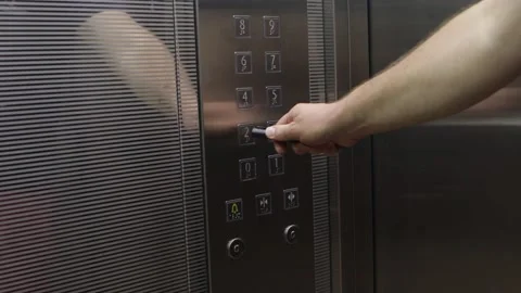 Man is pressing elevator's floor button with pen Stock Footage 140978271