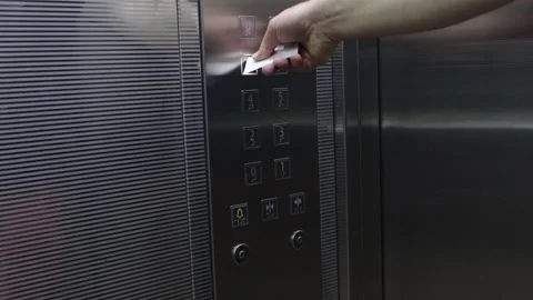 Man is pressing elevator's floor button with white nfc card Stock Footage 140978274