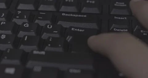 Man pressing enter key on computer keyboard, finger, macro, detail, close-up Stock Footage 232318618