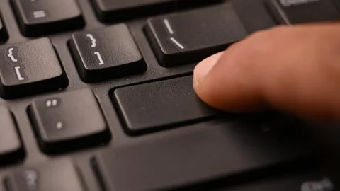 Man Pressing Enter Key on Keyboard for Command Execution Stock Footage 333550937