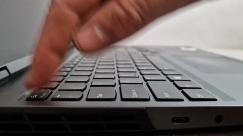 Man pressing escape button on laptop computer keyboard, finger pushing esc key Stock Footage 227760200
