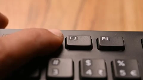 Man Pressing F2 Key on Keyboard to Rename File on Computer Stock Footage 333572709