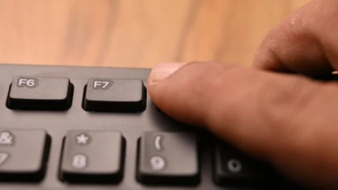 Man Pressing F8 Key on Keyboard for System Boot Option Selection on Computer Stock Footage 333576262