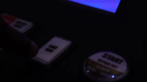 Man pressing flashing "take win" button on a slot machine in a casino Stock Footage 256793159