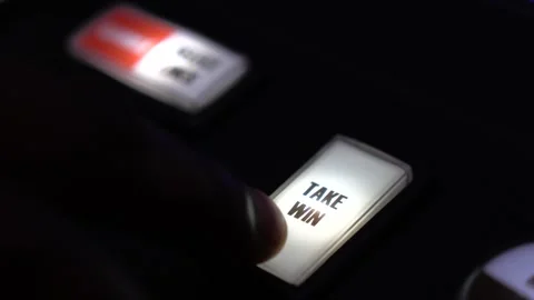 Man pressing flashing "take win" button on a slot machine in a casino Stock Footage 256793250