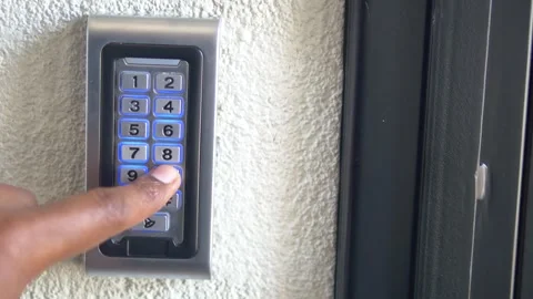 Man pressing glowing numbers on keypad for secure entry motion dynamic cine.. Stock Footage 332625962