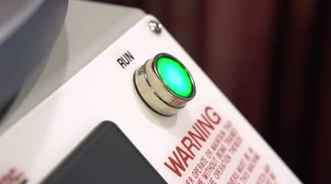 Man pressing Green Run button on machine 動画素材 21440642
