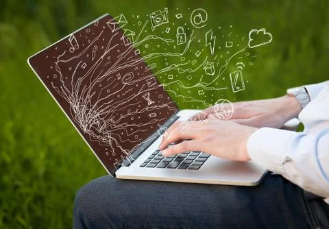 Man pressing notebook laptop computer with doodle icon cloud symbols Stock Photos