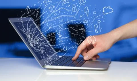 Man pressing notebook laptop computer with doodle icon cloud symbols Stock Photos