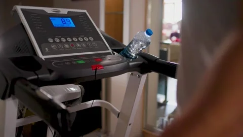 Man pressing red stop button on treadmill console after workout. Close-up o.. Stock Footage 332054754