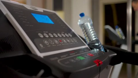 Man pressing red stop button on treadmill console after workout. Close-up o.. Stock Footage 332054894