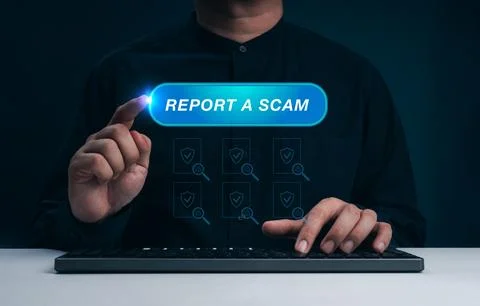 Man pressing Report a Scam button on virtual interface while using computer.. Stock Photos