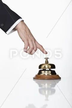 A man pressing a service bell, focus on hand Stock Photos
