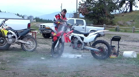 Man pressure washes motorcycle Stock Footage 43496595