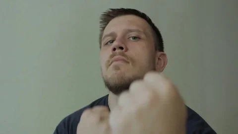 Man pretend to fight with the camera. Stock-Footage 77413562