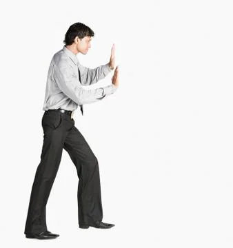 Man pretending to push an object Stock Photos