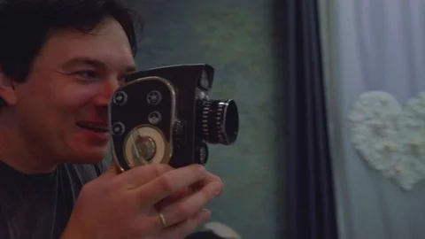 Man pretends making video with old fahioned camera Stock Footage 94648946