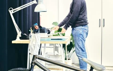 Man in the printer section of a coworking Stock Photos