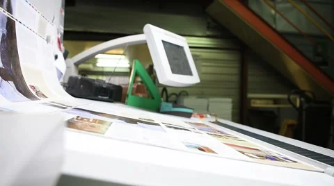 Man in printing house controling sample before edition Stock Footage 59786857