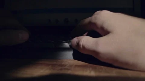 The man prints the last line of the malicious program on the keyboard before run Stock Footage 79614922