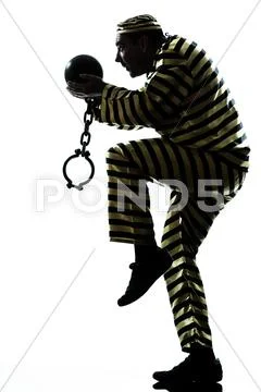 Man prisoner criminal with chain ball silhouette escaping Stock Photos