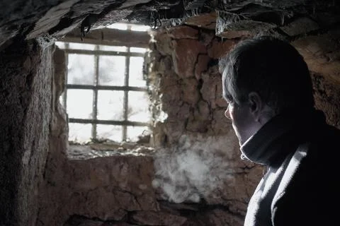 Man prisoner or captive in the dark underground cell Stock Photos