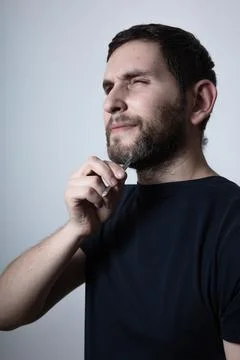 Man with problem of graying beard Plucking Hair with Tweezers from beard Stock Photos