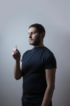 Man with the problem of graying beard Plucking Hair with Tweezers from his beard Stock Photos
